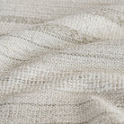 A cozy neutral upholstery fabric from Tonic Living with a basketweave and bouclé texture: close-up view.