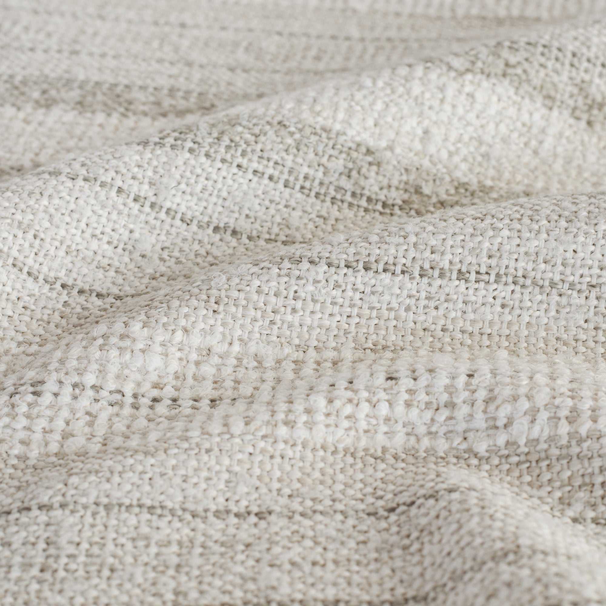 A cozy neutral upholstery fabric from Tonic Living with a basketweave and bouclé texture: close-up view.