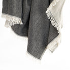 Tonic living charcoal grey and natural linen cotton throw blanket with a delicate fringe edge