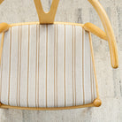 a beige, cream, ochre yellow and tan brown striped upholstered chair seat 