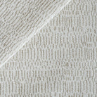 Avani Sand, a neutral upholstery fabric with an organic line pattern.