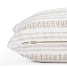 a white and tan striped throw pillow - close up zipper view