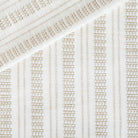 a white and tan intricate woven striped home decor fabric 