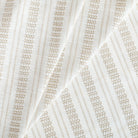 a white and tan intricate woven striped home decor fabric