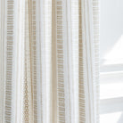 a white and tan intricate woven striped curtain fabric with a european flair