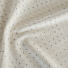 a pearly beige and ice blue diamond patterned chenille upholstery fabric from Tonic Living