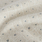 a pearly beige and ice blue diamond patterned chenille upholstery fabric: close up view