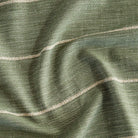 a leafy green and beige stripe upholstery fabric from Tonic Living