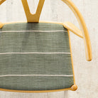 a leafy green with chunky wheat coloured horizontal stripe upholstered chair seat