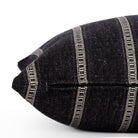 A black and white striped pillow: close up zipper view.