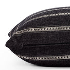 A black and white striped pillow: close up zipper view.