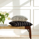 Black and white designer throw pillows from Tonic Living, styled on a bench.