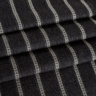 a faded black and soft white stripe upholstery fabric