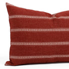 A red and white striped lumbar pillow, close up view.