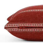 A red and white striped lumbar pillow: close up zipper view.