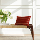 Red and white striped lumbar pillow from Tonic Living, styled on a bench.