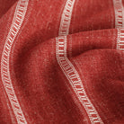 a crimson red and white stripe upholstery fabric : close up view