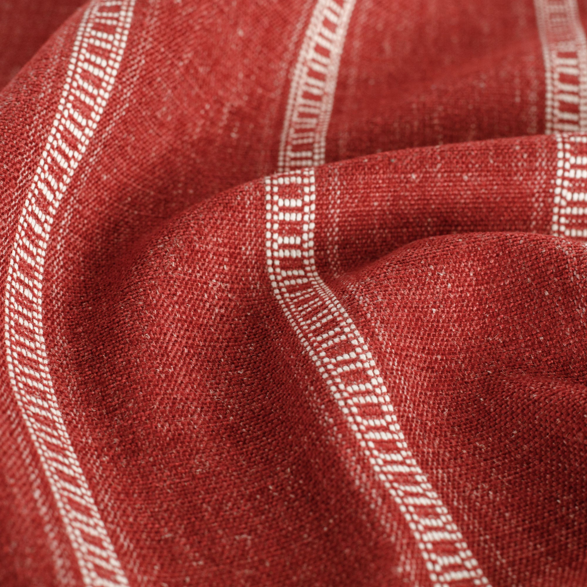 a crimson red and white stripe upholstery fabric : close up view