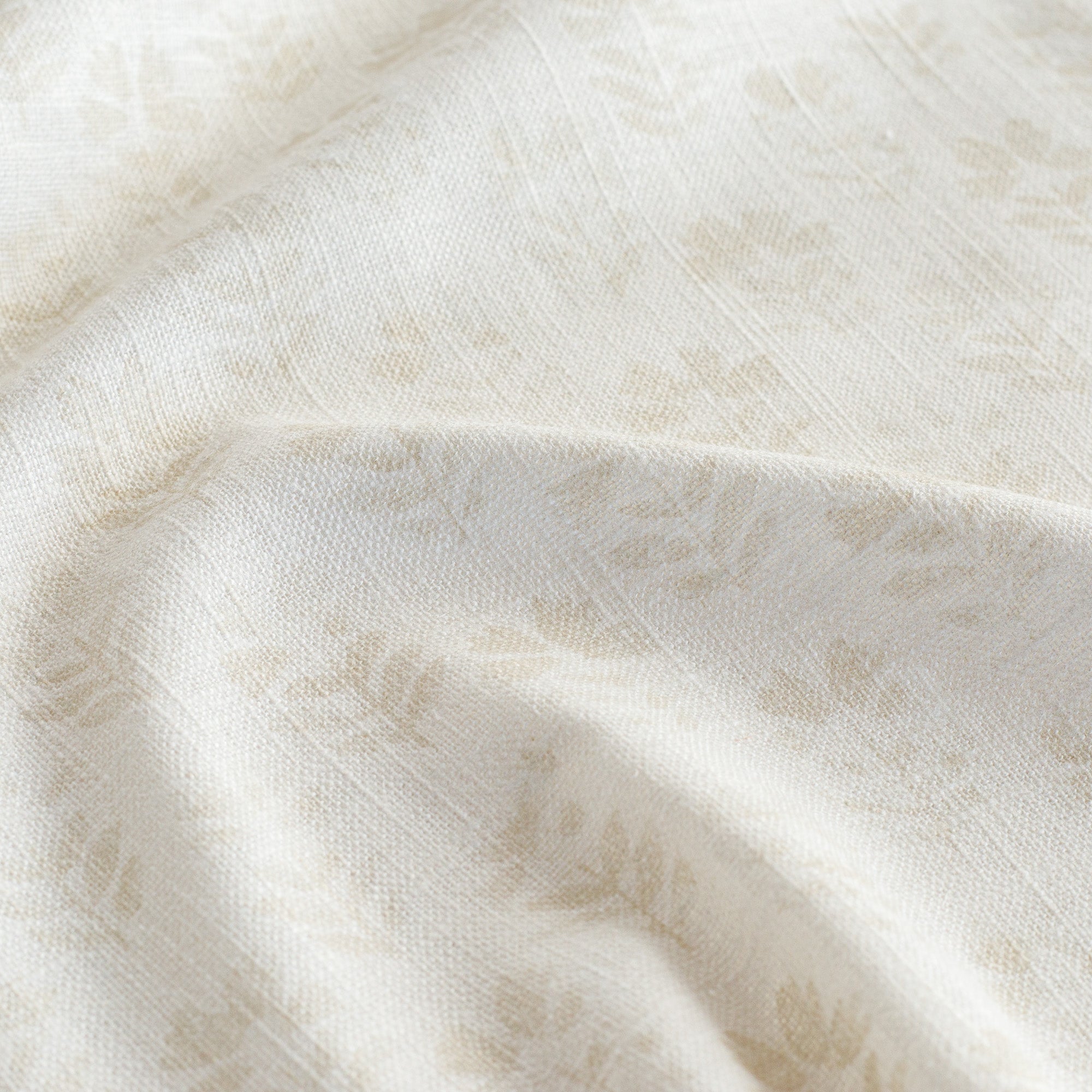 a tonal cream subtle block-print style floral print fabric : close up view