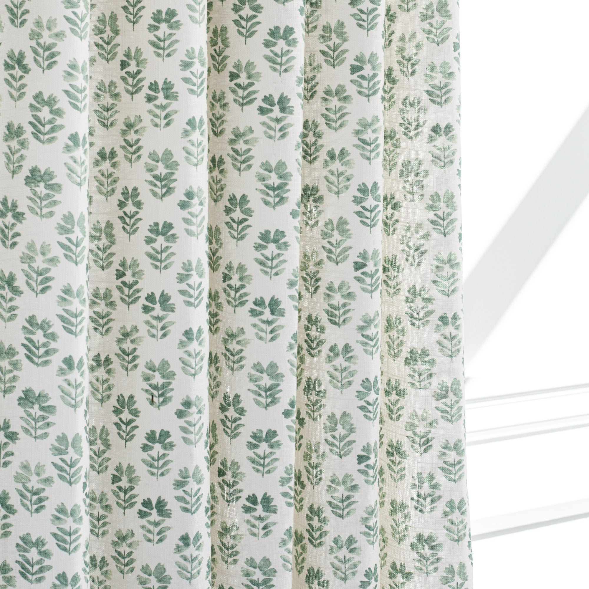 Carmel Pine, a drapery fabric from Tonic Living with a block print floral pattern.