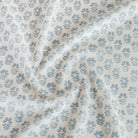 A soft white linen-blend fabric with blue flowers, a home decor fabric from Tonic Living.