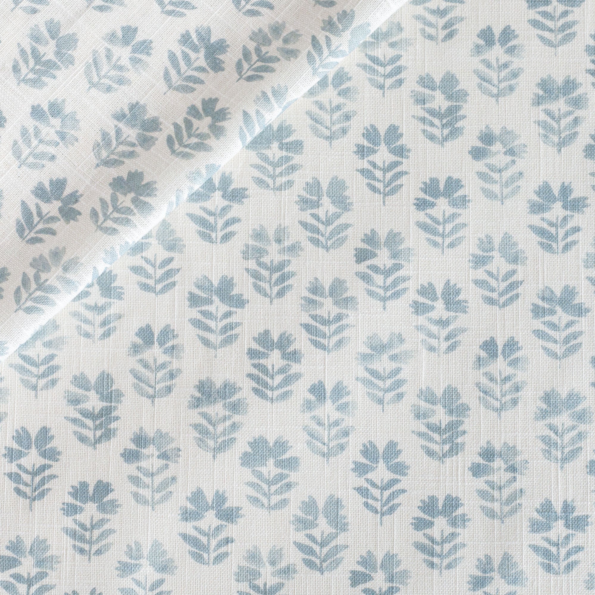 Carmel Sky Blue, a light-weight fabric with a blue and white floral block print from Tonic Living.