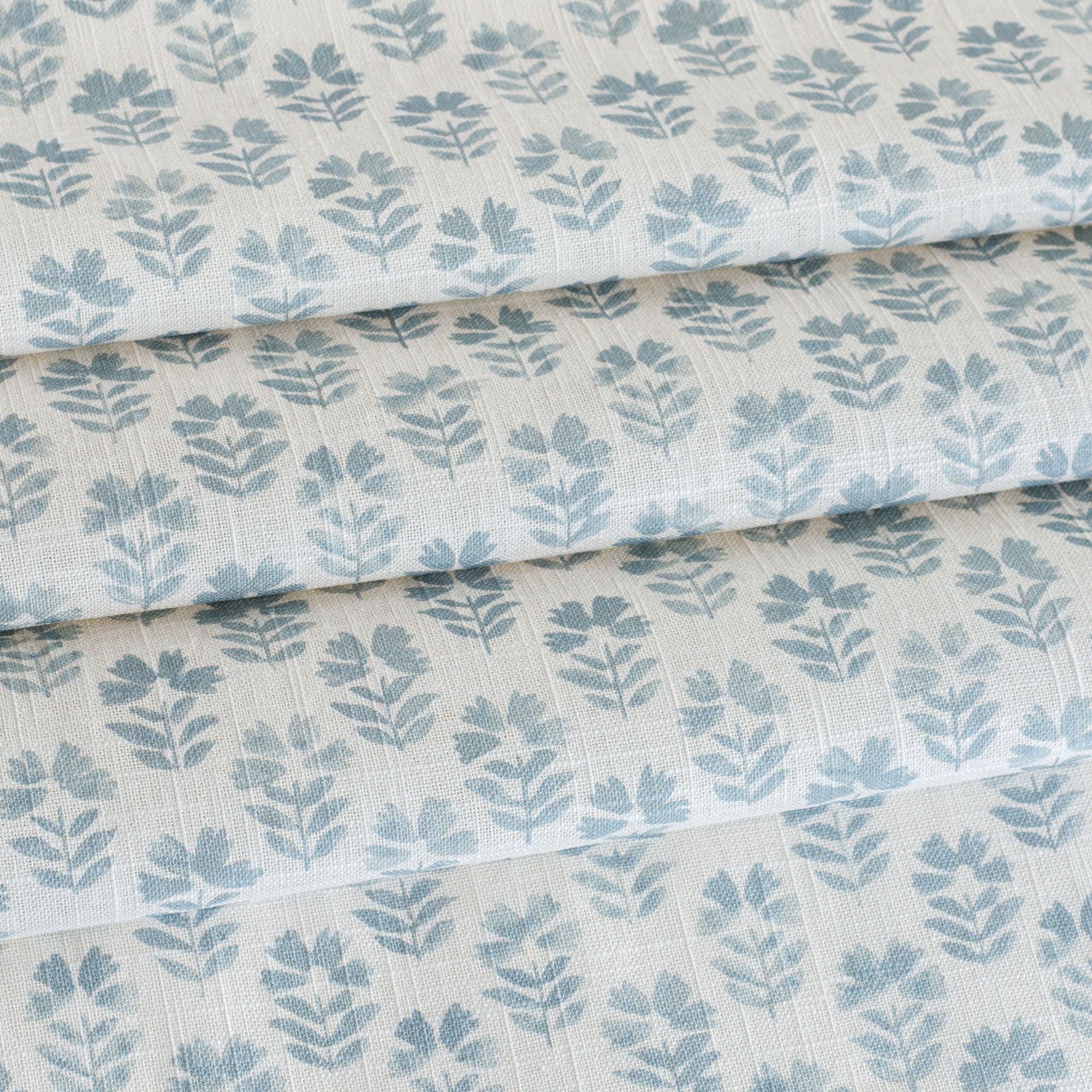 A white and blue block print floral fabric from Tonic Living.