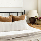 Tonic Living bed pillowscape: Blaine Cinnamon and Finn Stripe Natural Bolster