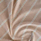 a rust red, parchment and black stripe home decor fabric from Tonic Living