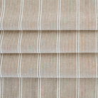 a brown, parchment and black stripe patterned multi-use fabric from Tonic Living