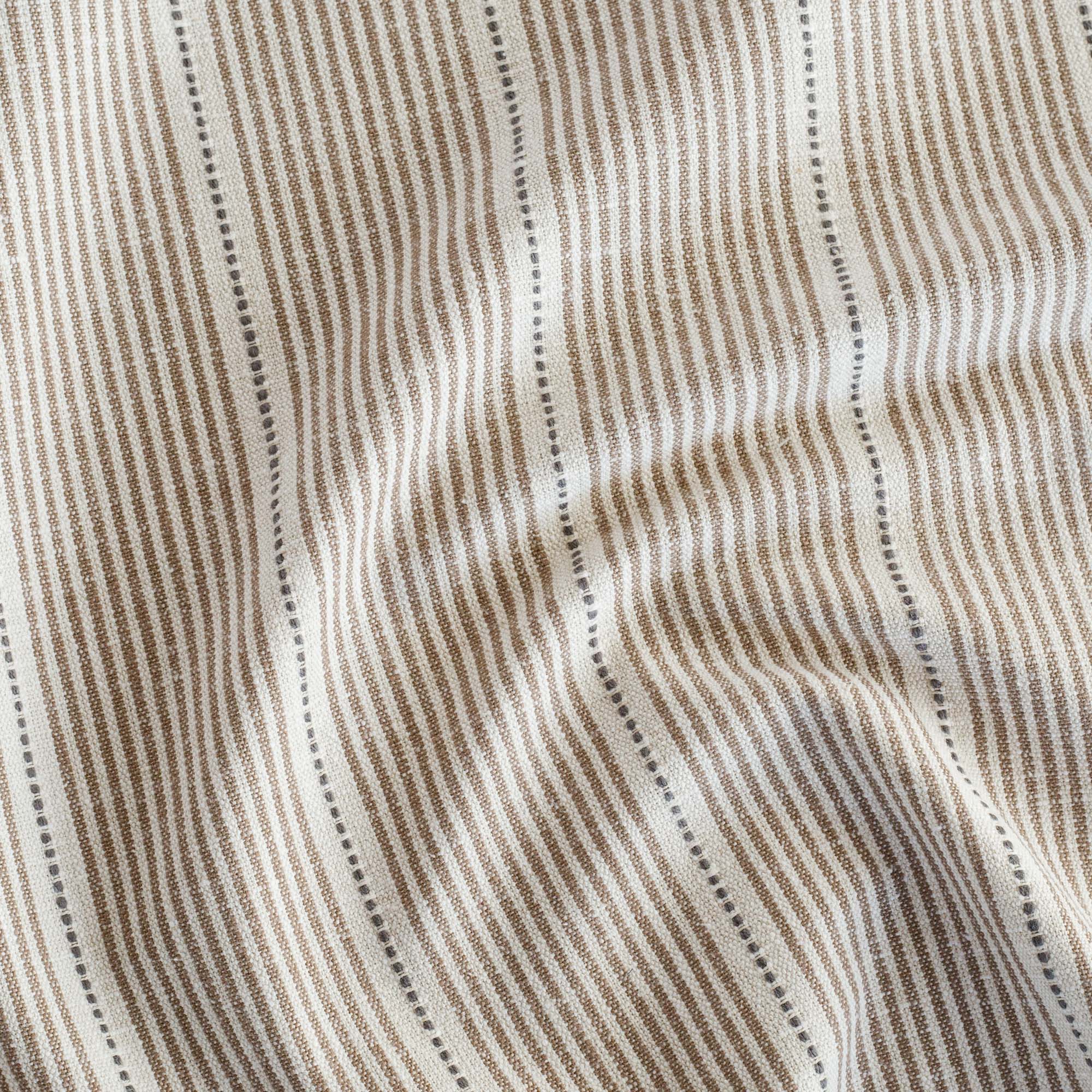 a brown, cream and black stripe patterned home decor fabric 