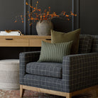 Tonic Living earth tone decor : hunter moss and Valentina velvet pillow on an armchair upholstered in Dundee Sable fabric