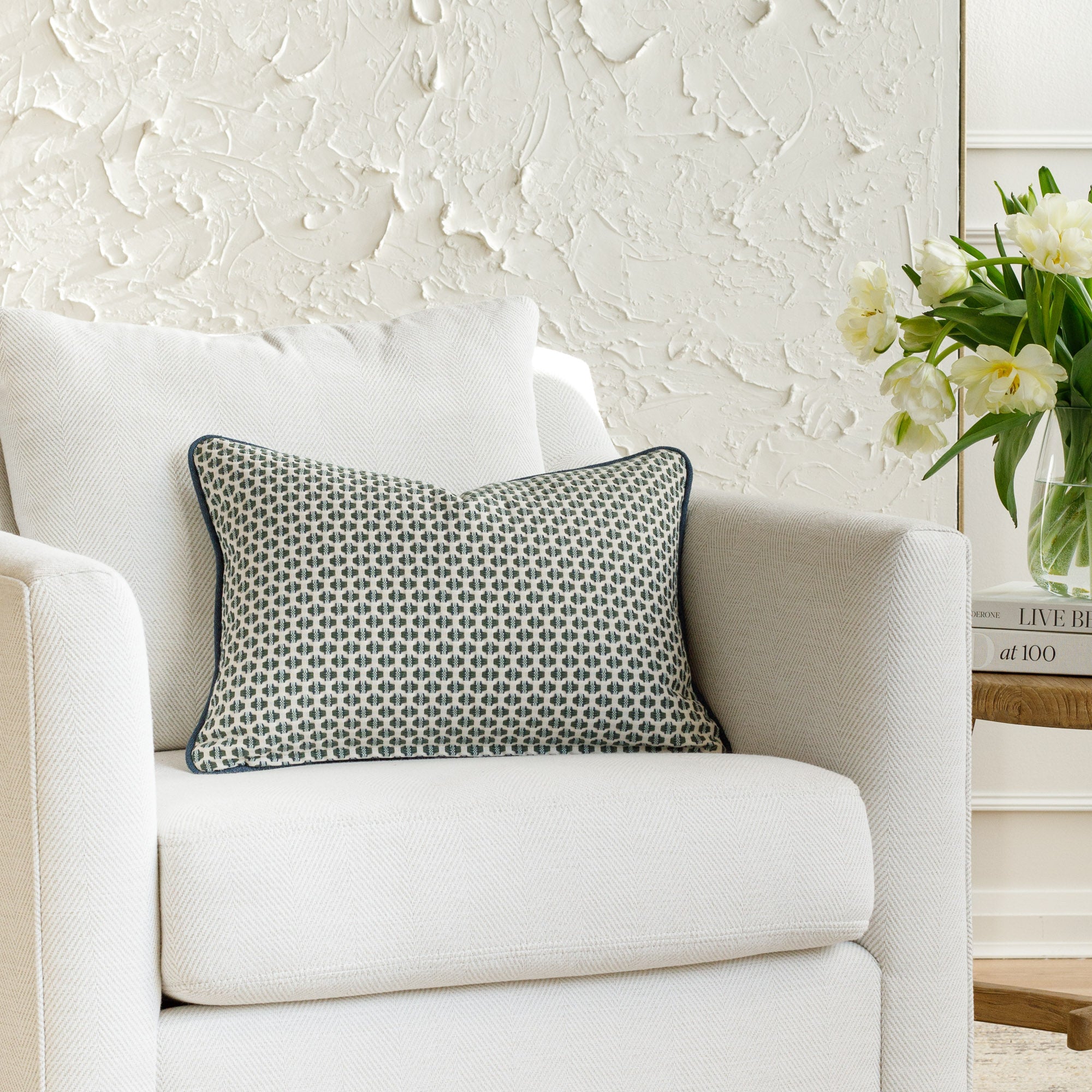 A geometric patterned pillow, styled on furniture.