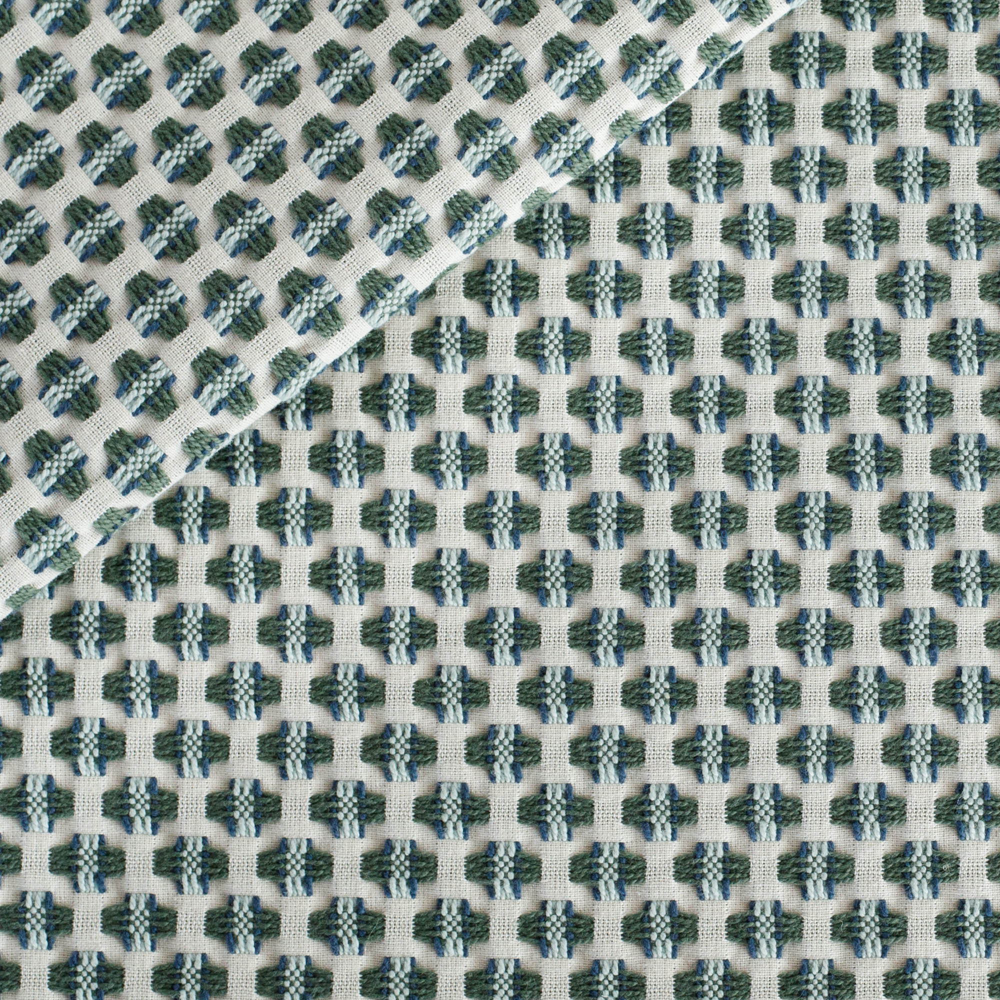 Kensington Lagoon fabric, a cream, blue and green intricate woven small geometric patterned upholstery fabric from Tonic Living