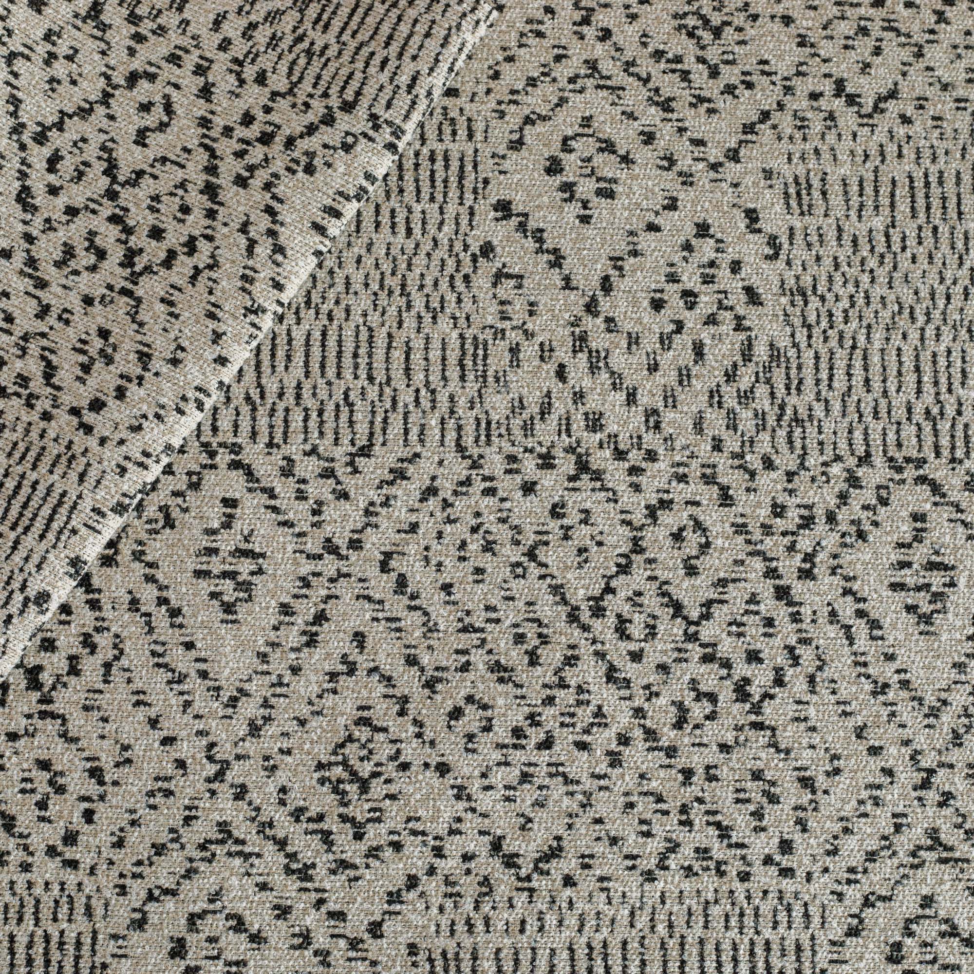 A beige and black home decor fabric from Tonic Living with an exotic ikat pattern.