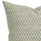 A meadow green and tan leaf-patterned pillow: close up view. 