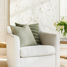 Green-toned designer toss pillows from Tonic Living, styled on furniture.