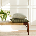 Green patterned throw pillows from Tonic Living, styled on a bench.