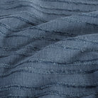 a navy blue upholstery fabric with a textured bouclé stripe: close up view