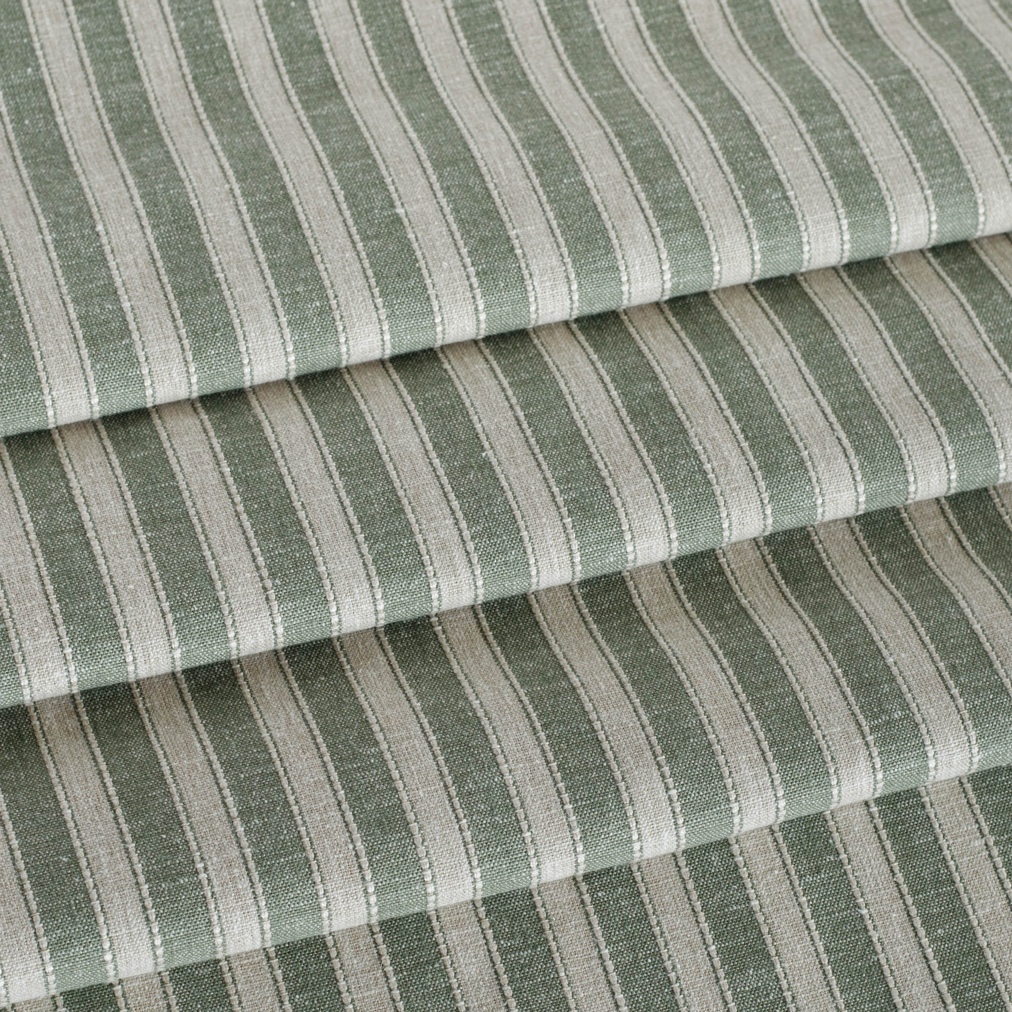 a sage green and oatmeal striped home decor fabric from Tonic Living