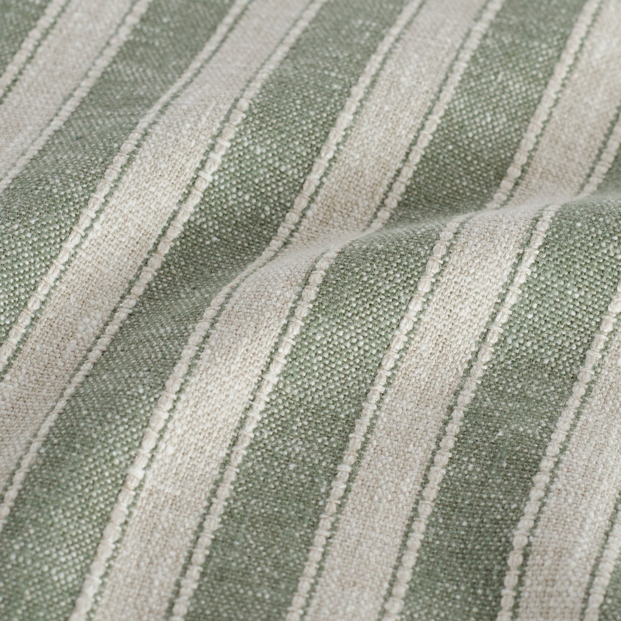 a sage green and oatmeal striped home decor fabric : close up view