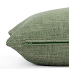 A leaf green and oatmeal slub pillow: close up zipper view.