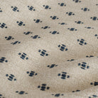 Pierce Navy, a preppy, traditional home decor fabric with a taupe background and a pattern of raised navy blue threads: close up view.