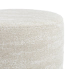 a creamy beige round ottoman - close up view