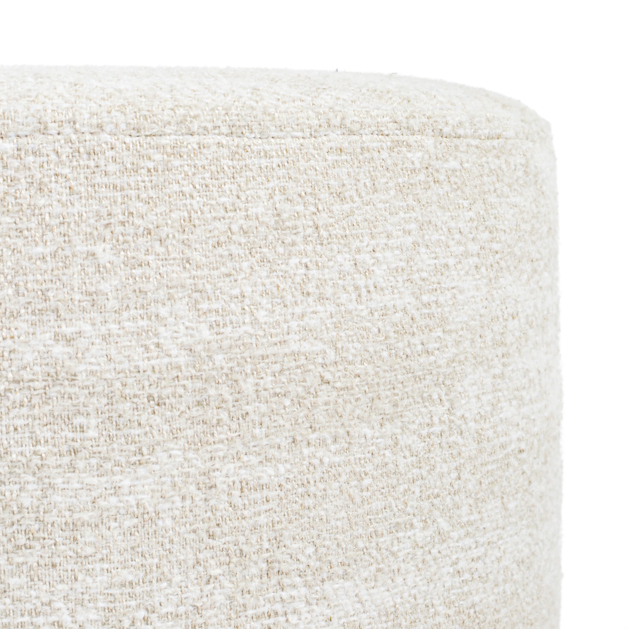 a creamy beige round ottoman - close up side view