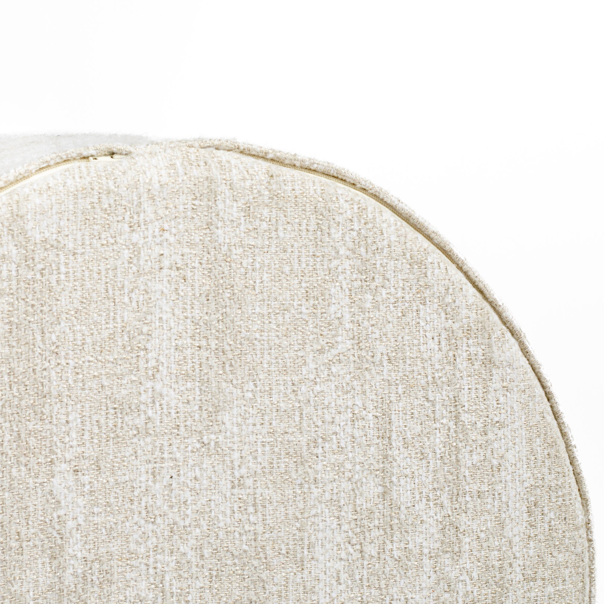 a creamy beige round ottoman - close up bottom view