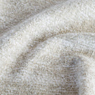 a cream textured flatweave and boucle upholstery fabric : close up view