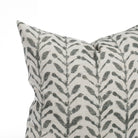 A charcoal grey and white pillow: close up view.