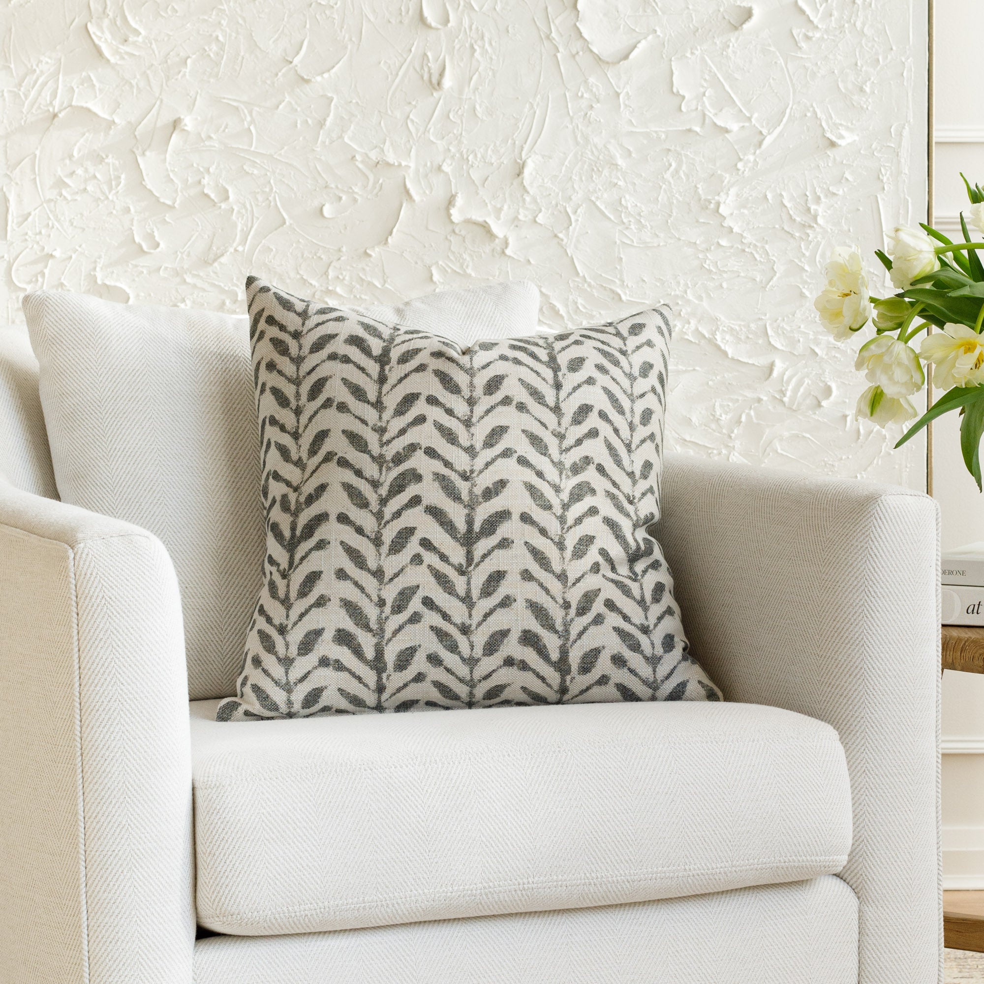 A patterned pillow from Tonic Living, styled on furniture. 