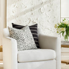 Black and white patterned throw pillows from Tonic Living, styled on a chair.